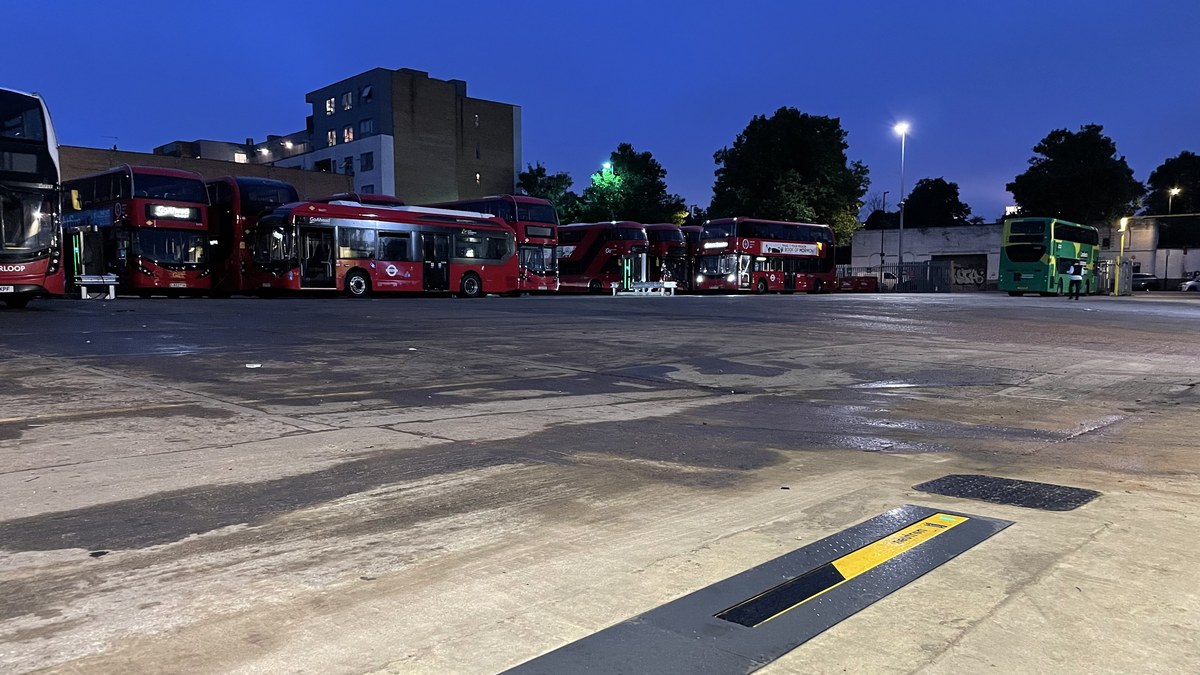 London bus depot at dusk with Neutron in-ground charger flush with the tarmac