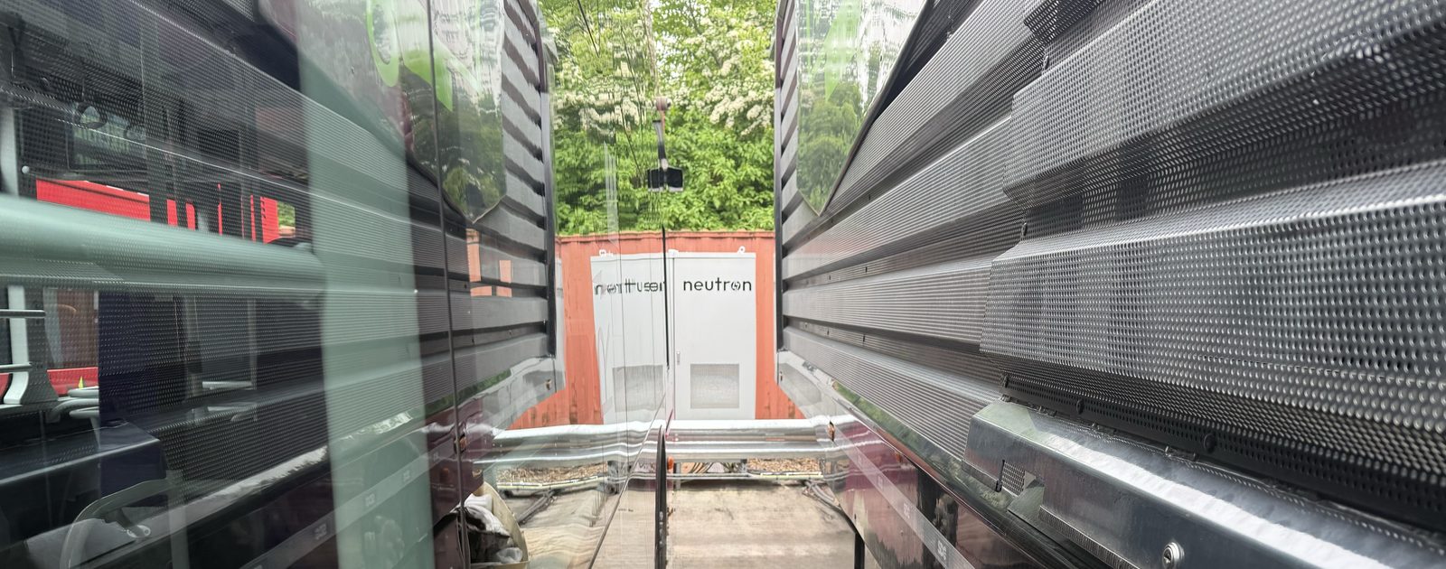 Neutron Master Unit charger positioned between two coaches at a UK bus and coach depot